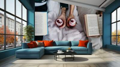 Beautiful couple reading a book with cocktails in the room Wall mural