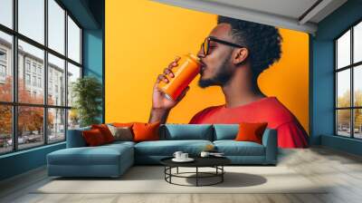 Side profile of African American man drinking fresh, cold drink, tasty beverage, soda carbonated liquid from blank metal or tin can with mockup isolated on background with empty copy space refreshment Wall mural