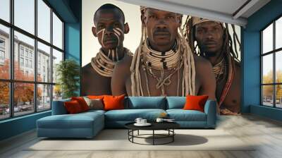 Three men in tribal outfits pose in the desert Wall mural