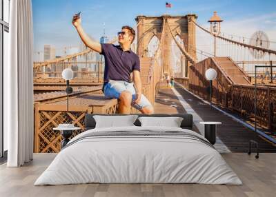 Tourist model taking a selfie on a Brooklyn Bridge Wall mural