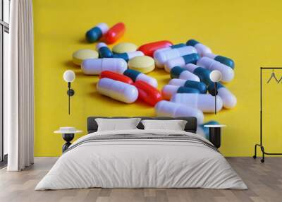 Colorful pills on yellow background.Pharmacy theme, health care, drug prescription for treatment medication and pharmaceutical medicament Wall mural