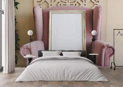 a blank picture frame placed on a wooden stand near a pink velvet armchair Wall mural