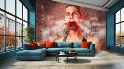 ridiculous expression of a man with hot chillies in his mouth Wall mural