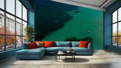 Aerial view of people bathing in a crystal clear sea. Wall mural