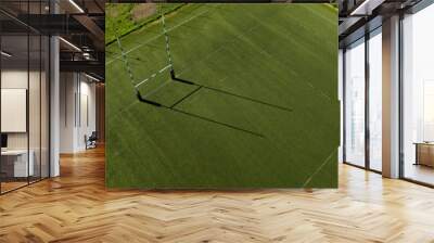 Aerial view of rugby goal post in a stadium on a sunny day. It is an artificial turf rugby field. The sports facility is empty. Wall mural