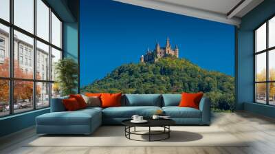 Aerial view of famous Hohenzollern Castle, ancestral seat of the imperial House of Hohenzollern and one of Europe's most visited castles, on the top of a green hill in Baden-Wurttemberg, Germany Wall mural