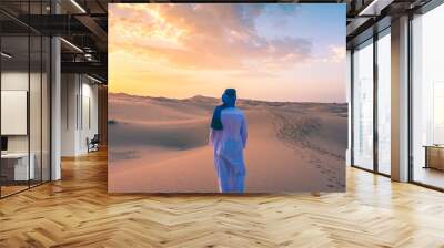 Berber man wearing traditional tuareg clothes in the Sahara Desert at dawn, Merzouga, Morocco Wall mural