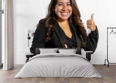 Portrait of hispanic female business person, giving a thumbs up and smiling happily, waist up photo, isolated on white Wall mural