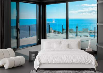 Empty rooms in a new house with large windows overlooking the sea. Automatic blinds. Glass partition terrace. Wall mural