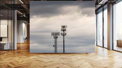 Two towers providing cellular broadband and data service to rural areas on stormy day. Illustrates digital divide. Wall mural