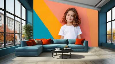 A young girl is standing in front of a colorful wall, wearing a white shirt Wall mural