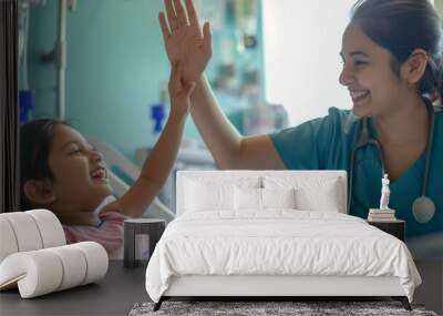 woman nurse or medical staff give a high five to little girl patient Wall mural