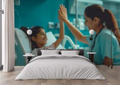 woman nurse or medical staff give a high five to little girl patient Wall mural