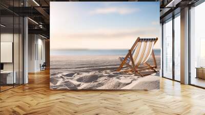 a traditional style striped deckchair sits on a sandy beach space for copy Wall mural