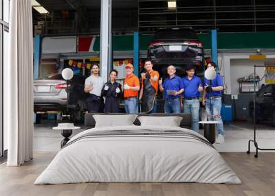 Group of seven car service technician men and woman stand in line at workplace, people work  together at vehicle repair garage service shop, check and repair customer car at automobile service center Wall mural