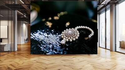 Indian bride's beautiful wedding jewelry decorated with pearls on black surface Wall mural