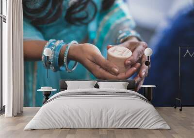 Indian bride's hands, gloves, rings, mehendi and jewellery close up Wall mural