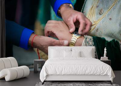 Indian groom's wearing his watch close up Wall mural