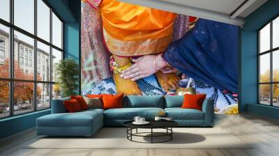 Indian Hindu pre wedding Haldi ceremony ritual items, decorations, hands close up Wall mural