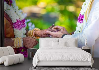 South Indian Tamil couple's exchanging wedding rings hands close up Wall mural