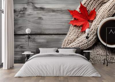 A fall themed setup with a cup of coffee cozy sweater and a red maple leaf on a wooden backdrop providing a blank area for text. Creative banner. Copyspace image Wall mural