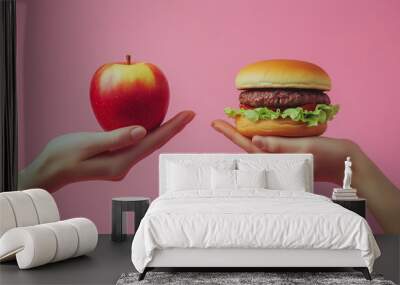 One hand holding apple fruit, other holding hamburger. Healthy natural organic fresh vegetarian food vs unhealthy processed fast junk food meat. Nutrition diet lifestyle, fitness eating choice Wall mural