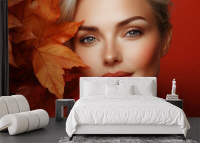 Portrait of beautiful adult woman with autumn leafs. Healthy clean fresh skin natural make up beauty eyes on red background, advertising banner of organic natural cosmetic products for facial skin Wall mural