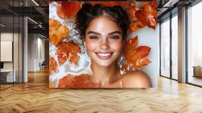 Portrait of beautiful young smiling woman with autumn leafs. Healthy clean fresh skin natural make up beauty eyes on white background Wall mural