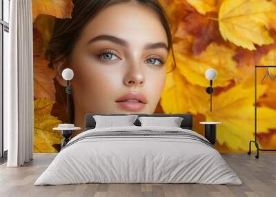 Portrait of beautiful young woman with autumn leafs. Healthy clean fresh skin natural make up beauty eyes on gold leafs background  Wall mural