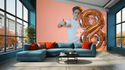 Boy with a balloon in the form of the number eight Wall mural