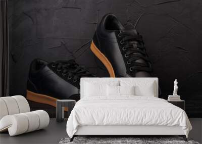 men's black sneakers on a black background Wall mural