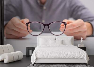 reading glasses in hand Wall mural