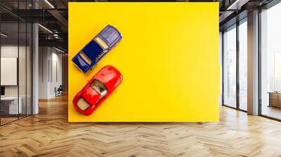 two toys cars on yellow background Wall mural