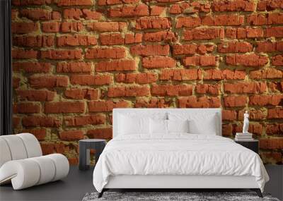 An old scratched red brick wall background. Close up. Wall mural