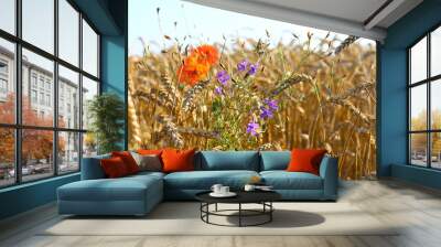 Wonderful summer landscape. blue flowers and poppies in the middle of a ripe wheat field. Idea concept of harvest. rural landscapes with blue sky with sun. creative image. Wall mural