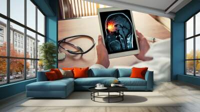 Doctor holding a digital tablet with x-ray of brain and skull skeleton. Headache, meningitis and migraine concept Wall mural