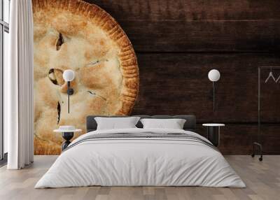 Homemade apple pie dessert shot from overhead over a dark wooden table top with room for copy space. Wall mural