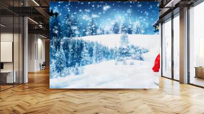 Santa has lost his hat when he left the North Pole while flying on his sleigh led by the reindeer on Christmas night. Wall mural