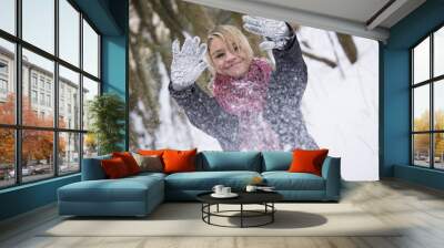 Pretty Woman with gloves covered in snow Wall mural