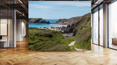 Wild rugged beach on a sunny day at low tide. With cliffs behind. Marloes Sands, Pembrokeshire. UK Wall mural