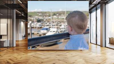 Young boy overlooking a marina in summer  Wall mural