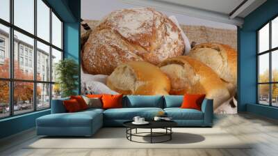 Closeup of basket with one Italian bread and three baguettes or french breads.  Wall mural