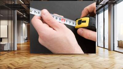 Hand with a measuring tape Wall mural