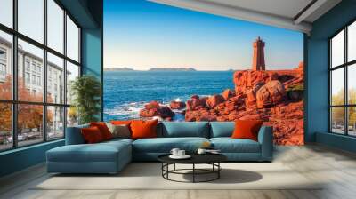 Ploumanach lighthouse sunset in pink granite coast, Brittany, France. Wall mural