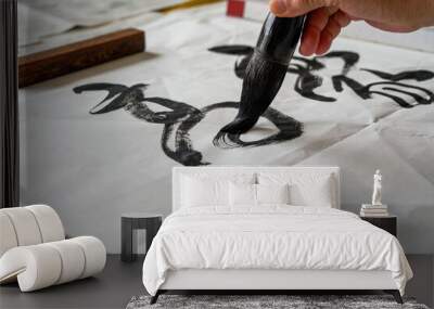 A calligrapher is writing calligraphy characters with a large brush, a close-up of the brush. Translation: The heights are too cold Wall mural