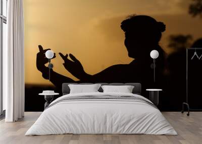 Beautiful silhouette of a Hula Dancer at Sunset on the Hawaiian Island of Maui Wall mural