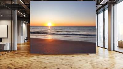 Beautiful morning sunrise over the ocean at the beach with warm sunlight shining on peaceful sea with calm gentle surf and waves at Pawleys Island, South Carolina low country lifestyle by the seashore Wall mural