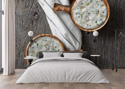 Flat lay with two bowls of homemade Clam Chowder bowls on a rustic wood table with a kitchen towel. Wall mural