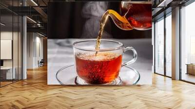 Cup of tea with a teapot on a dark background Wall mural