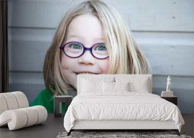 Female child with a happy face with glasses on Wall mural